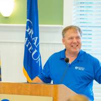 An alumnus speaks before Move-In